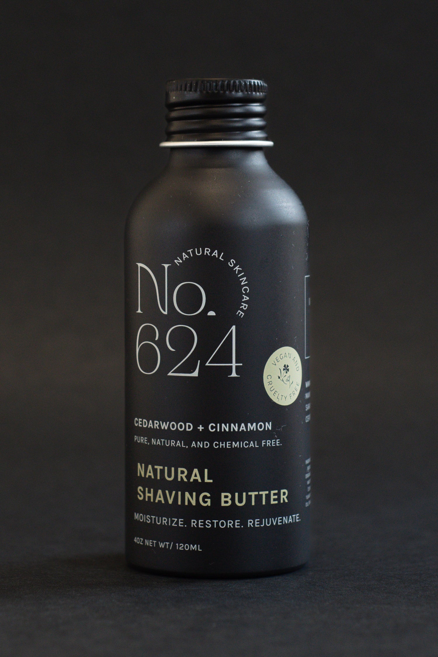 A black bottle of No.624 Natural Shaving Butter with cedarwood and cinnamon.
