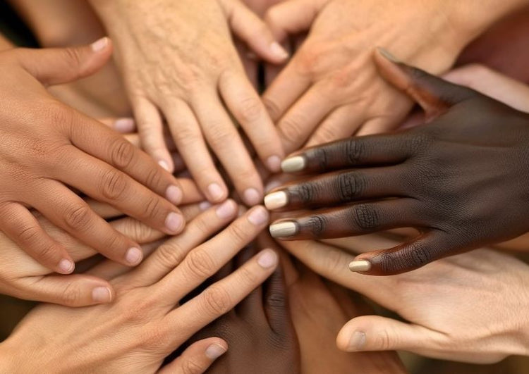 A close-up of diverse hands coming together, symbolizing the No.624 community and connection.