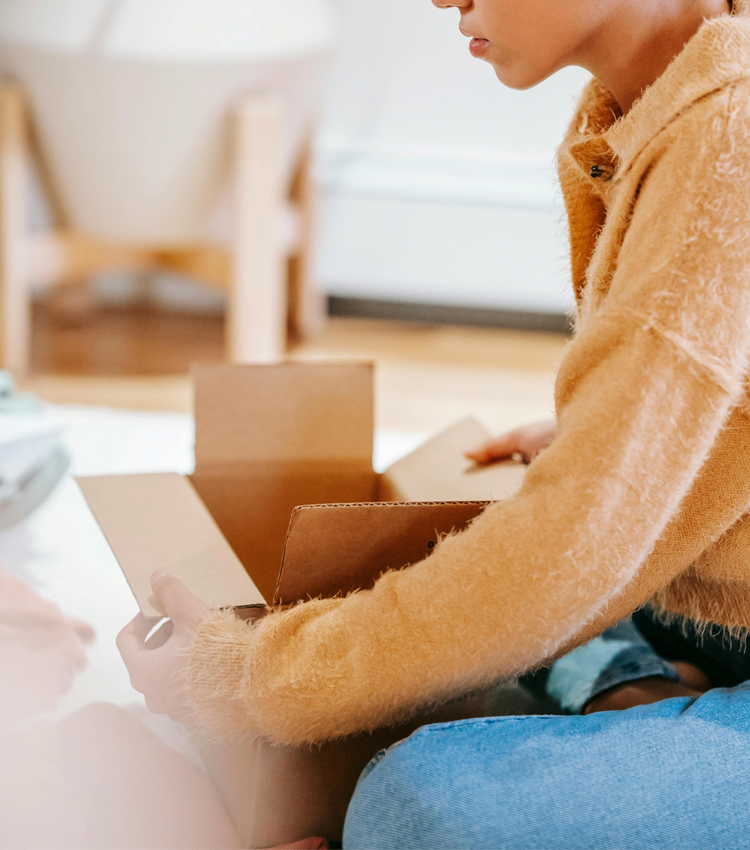 A person opening a No.624 parcel, anticipating enjoyment and engagement as a subscriber.